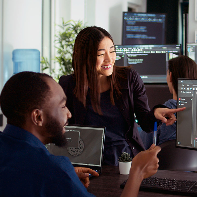 Team of diverse programers doing highfive gesture after coding database, celebrating cloud computing achievement.